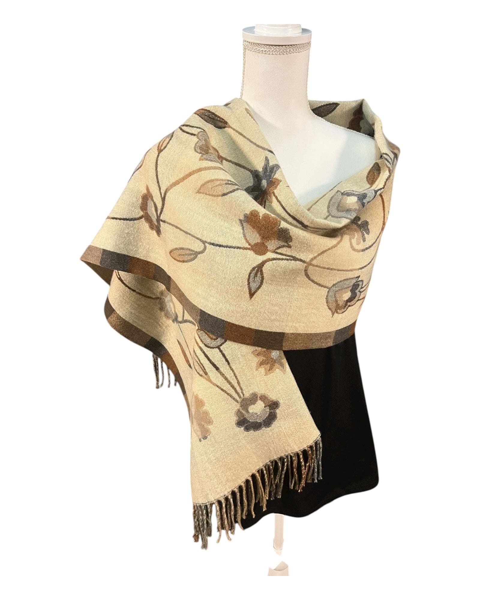 Beige floral patterned scarf with fringe on a mannequin against a white background